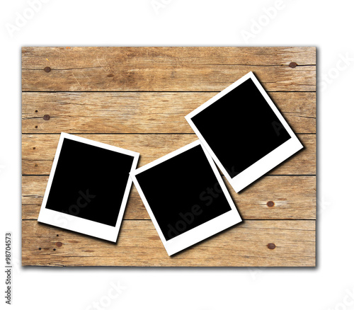 Stock Photo:Polaroid photo frames on old wooden background
