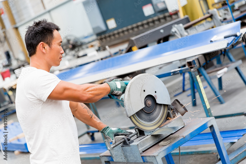 Asian worker in production plant on the factory floor Asian worker in production plant on the factory floor