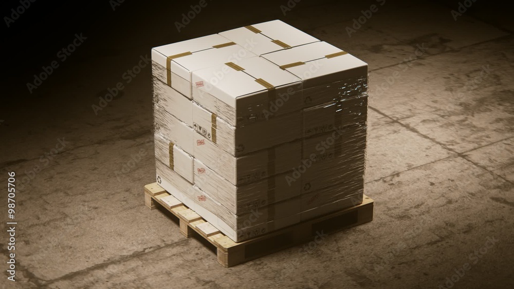 A stack of cardboard boxes on a pallet in the warehouse waiting for a forklift. A stack of cardboard boxes on a pallet in the warehouse waiting for a forklift.