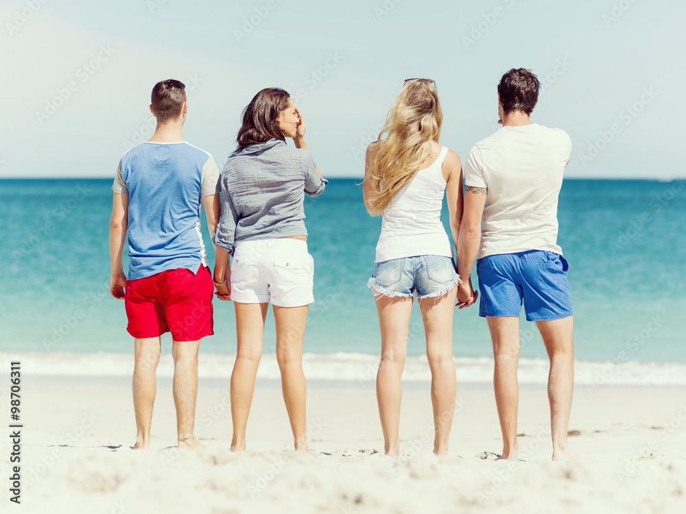 Company of young people on the beach