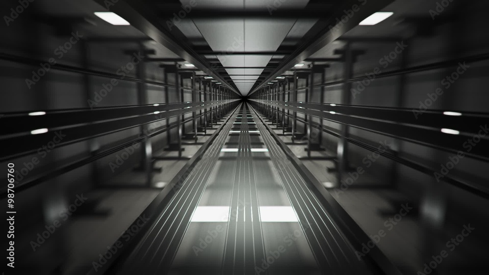 Inside the dark elevator shaft. Vertical construction witch machinery and ropes.