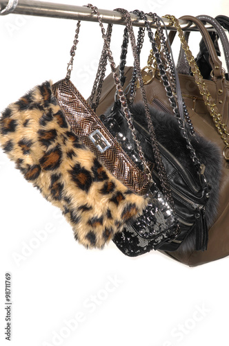 Fashion female fur, leather hand bag on hangers