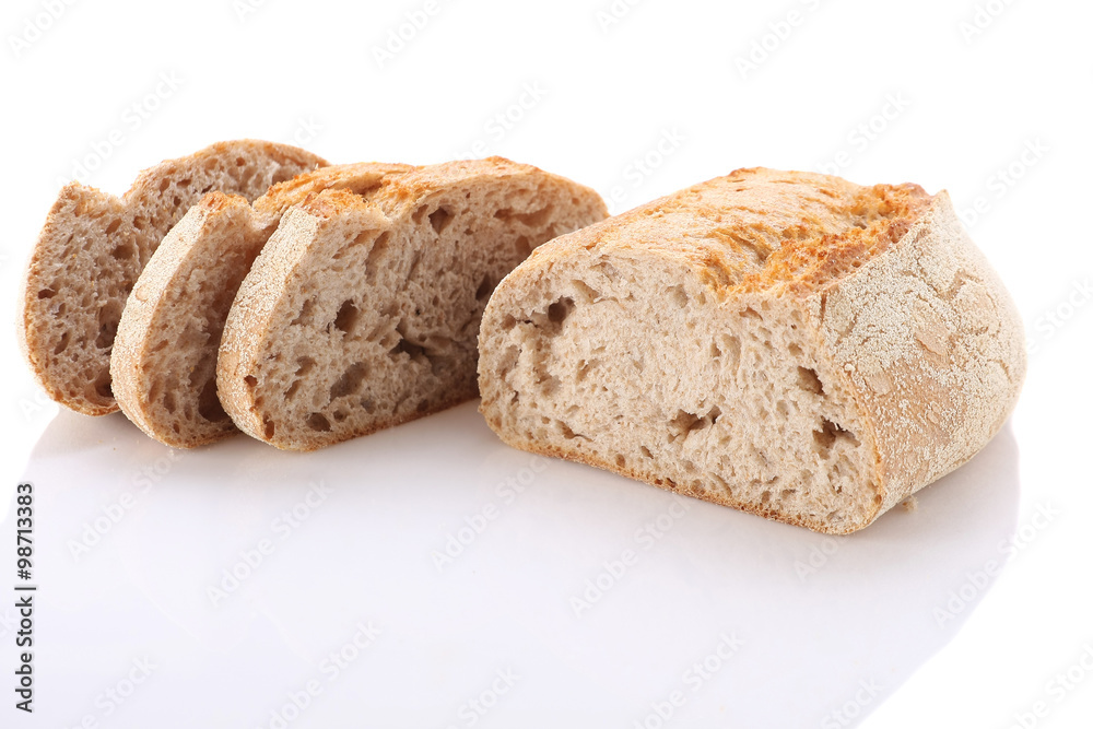 loaf and slices of bread on a white background