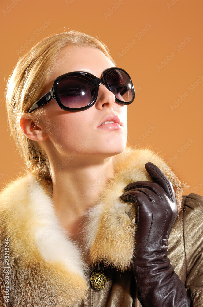 Close up fashion model in sunglass posing in the studio Close up fashion model in sunglass posing in the studio