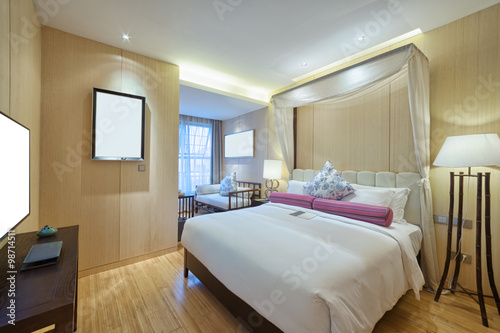 interior of modern bedroom with comfortable bed and sofa © zhu difeng