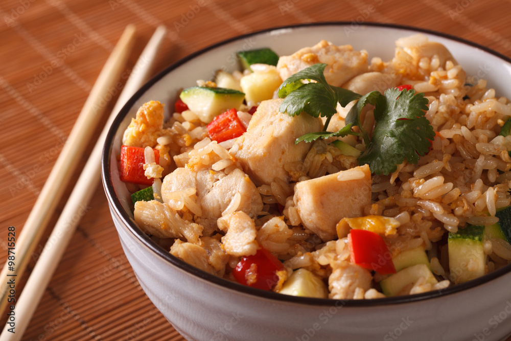 Japanese food: fried rice with chicken and vegetables close up. Horizontal
