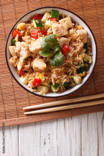 Tyahan - fried rice with chicken and vegetables. vertical top view 