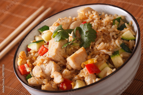 Japanese fried rice Tyahan with chicken in a bowl closeup. horizontal
