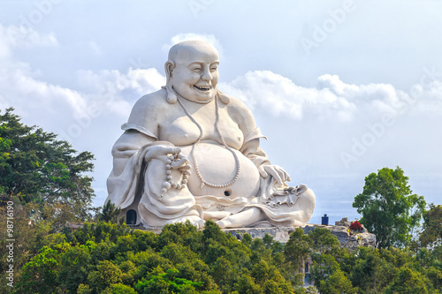 Canvas Print Architectural Specification biggest Maitreya Buddha merciful smile, bright white amnesty on high peaks attracts many Buddhists to pray for peace