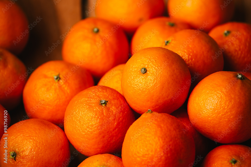 many fresh tangerines on a wooden background many fresh tangerines on a wooden background