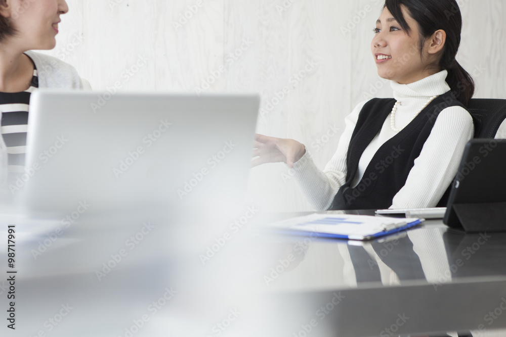 Women are talking with co-workers in the office Women are talking with co-workers in the office