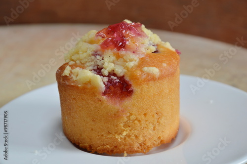 blueberry muffin in paper cup on wooden