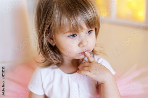 Girl holding finger in mouth