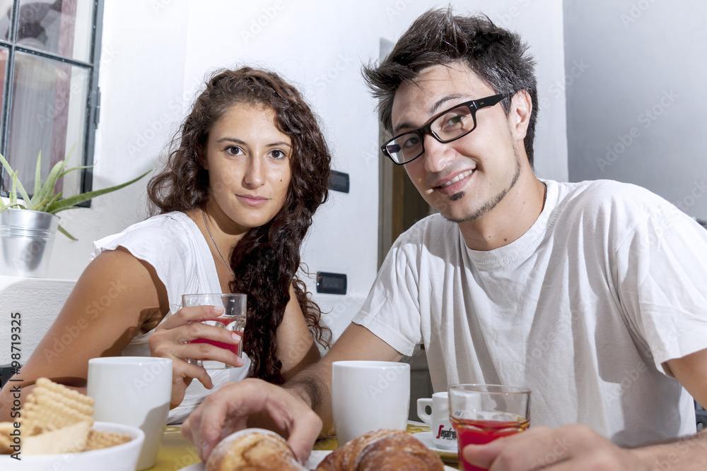 teenage couple has breakfast at home