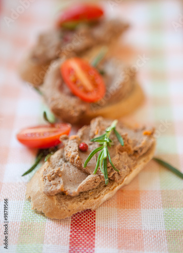 Chicken liver pate on bread with cherry tomatoes  