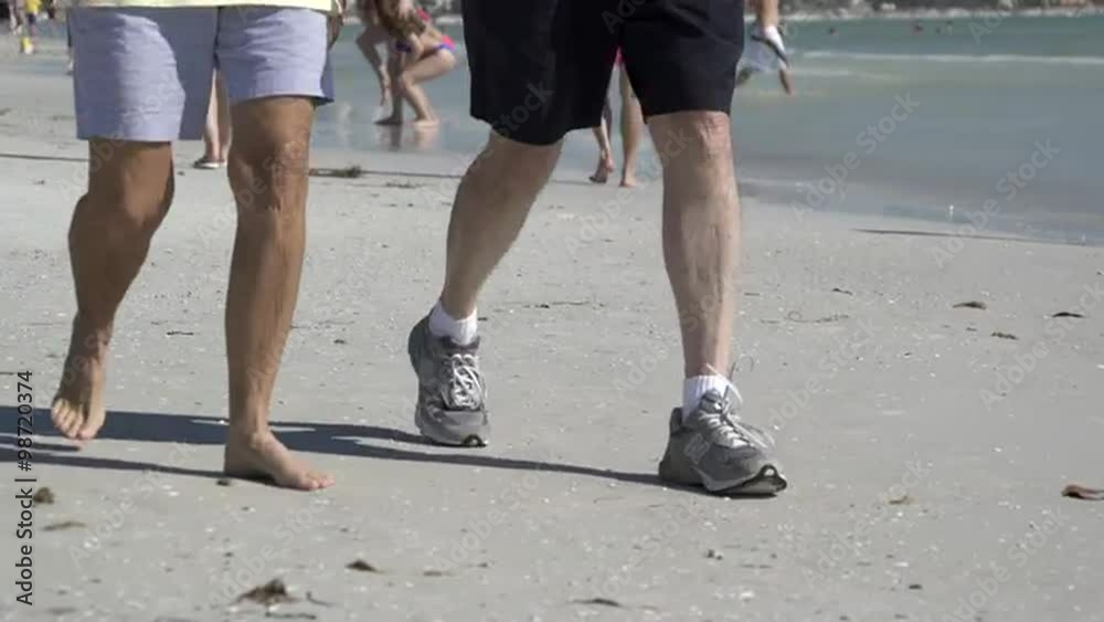 People enjoy a sandy beach on a sunny day People enjoy a sandy beach on a sunny day
