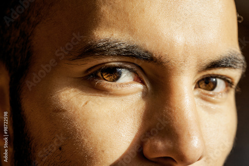 Man's brown eyes looking into the camera