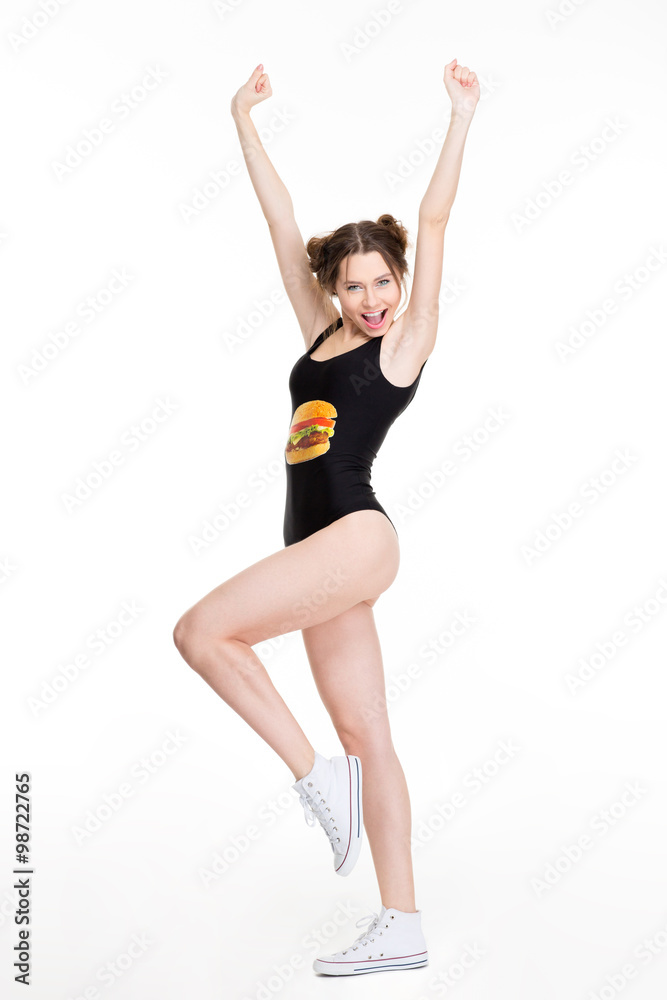 Positive excited young woman print dancing and jumping like cheerleader