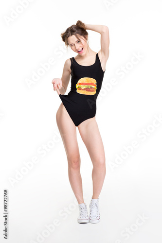 Cheerful winking young woman in black swimwear with hamburger print © Drobot Dean