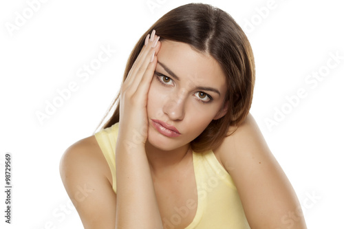 unhappy and bored young woman on a white background