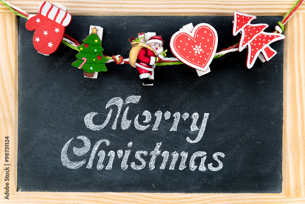 Christmas decorations over Vintage Chalkboard with wooden frame with Merry Christmas greeting