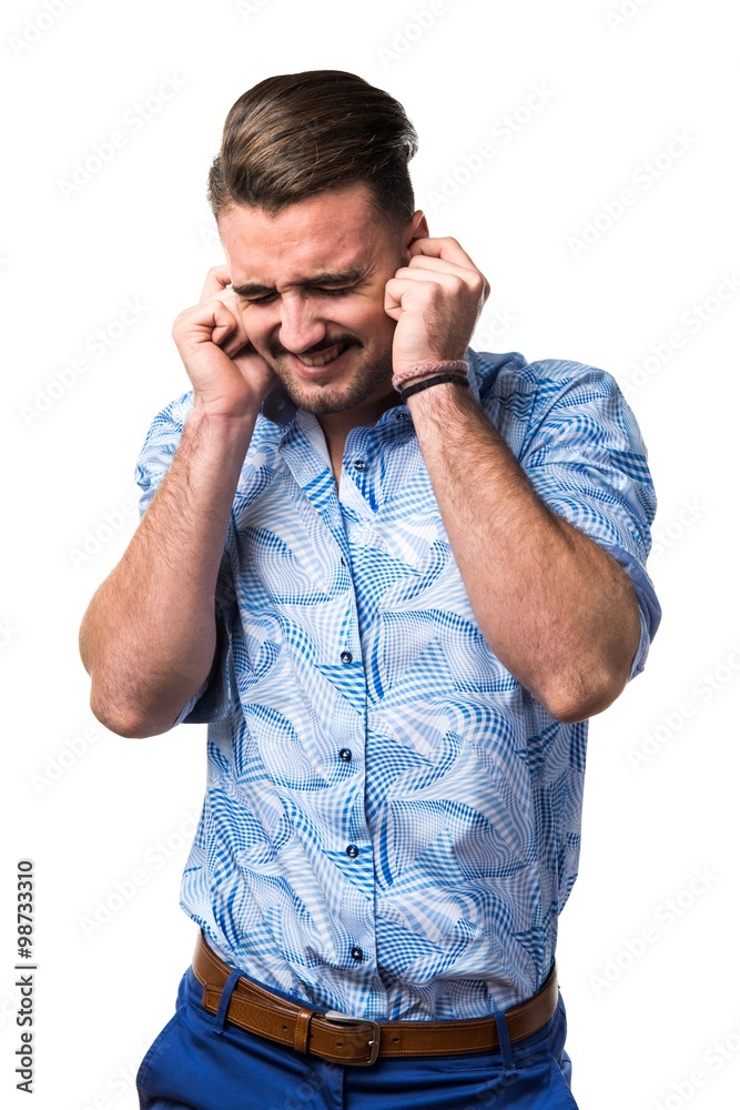 Handsome man covering his ears Handsome man covering his ears