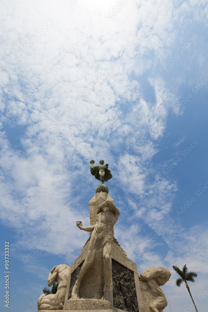 Sculptures and fountain with blue sky in Trujillo