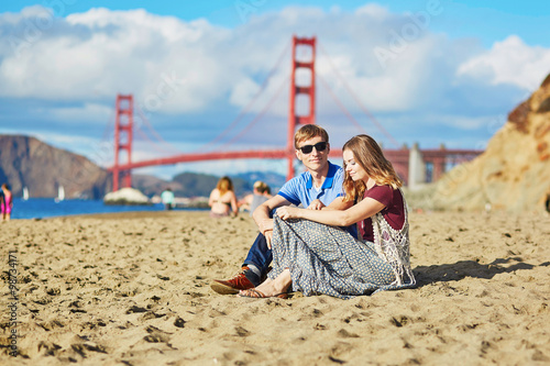 Romantic loving couple having a date on Baker beach in San Francisco photo