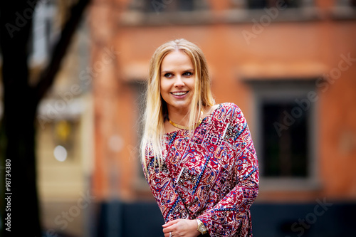 beautiful woman on the background of houses smiling