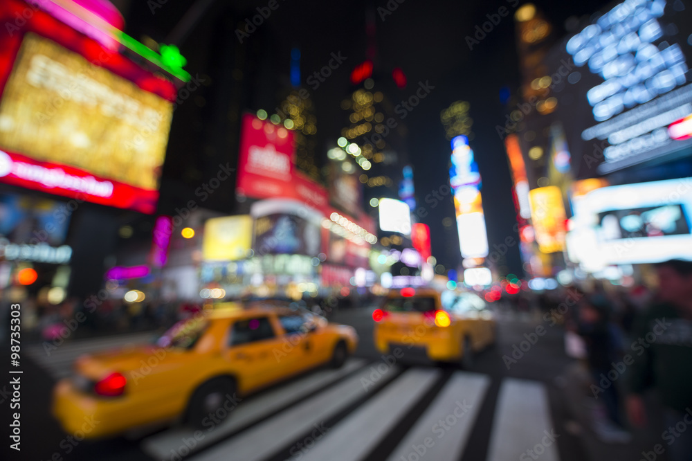 Fototapeta premium Defocus view of Times Square signage, traffic, and holiday crowds in the lead-up to New Year's Eve
