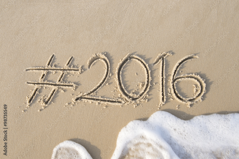 Hashtag social media message for 2016 written in smooth sand with