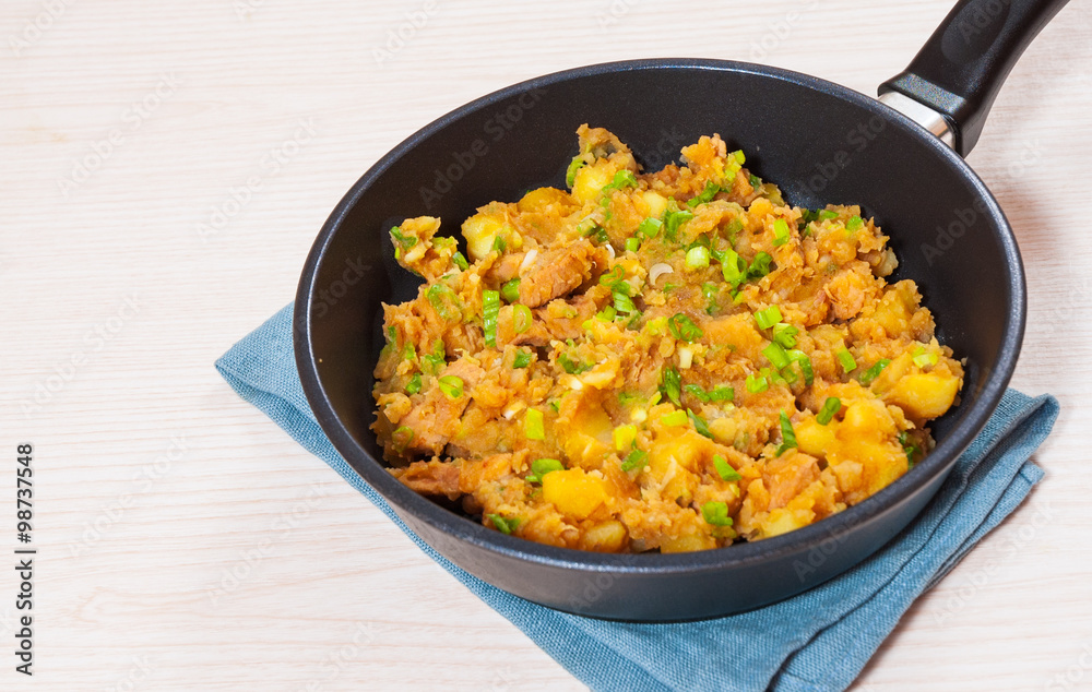 stewed meat with potatoes, onion in a frying pan stewed meat with potatoes, onion in a frying pan