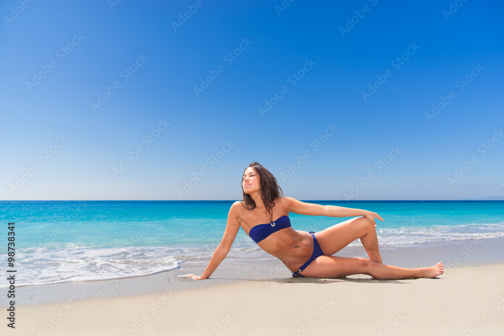 beautiful young girl pointing to the sea on tropical beach beautiful young girl pointing to the sea on tropical beach