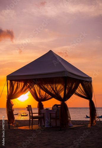Fototapeta Naklejka Na Ścianę i Meble -  Romantic dinner setting on the beach at sunset