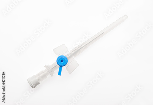 Blue plastic catheter with needle closed by protective cap isolated on white background. Clipping path included.