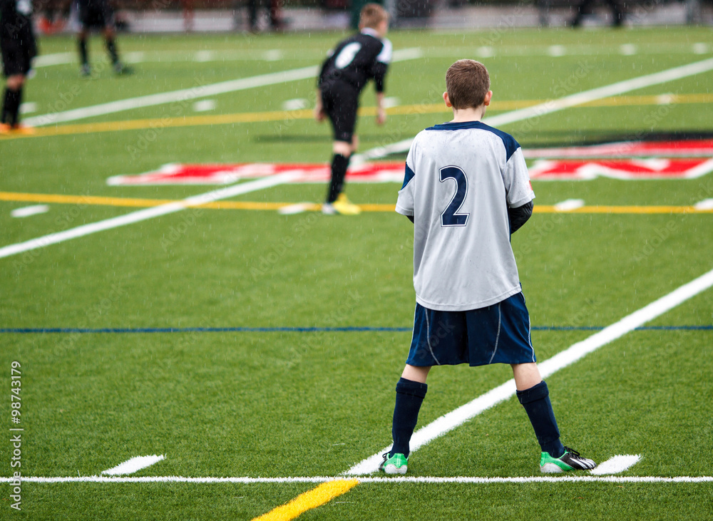 Soccer midfielder waiting for action in the rain... Soccer midfielder waiting for action in the rain...