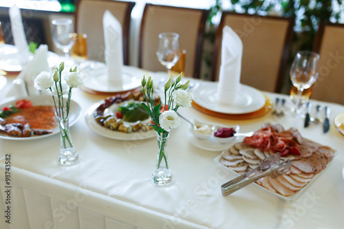 Elegant stylish decorated wedding reception tables with glasses