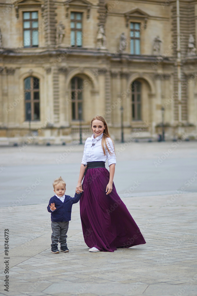 Fototapeta premium Beautiful young mother and her adorable toddler son in Paris
