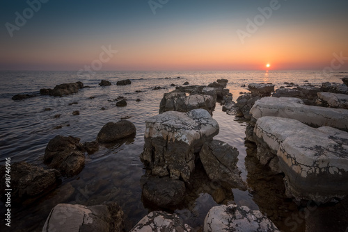 Sunset Over the Sea with Rocks in Foreground © kaycco