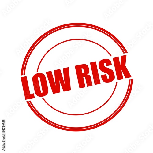 Low risk red stamp text on circle on white background photo