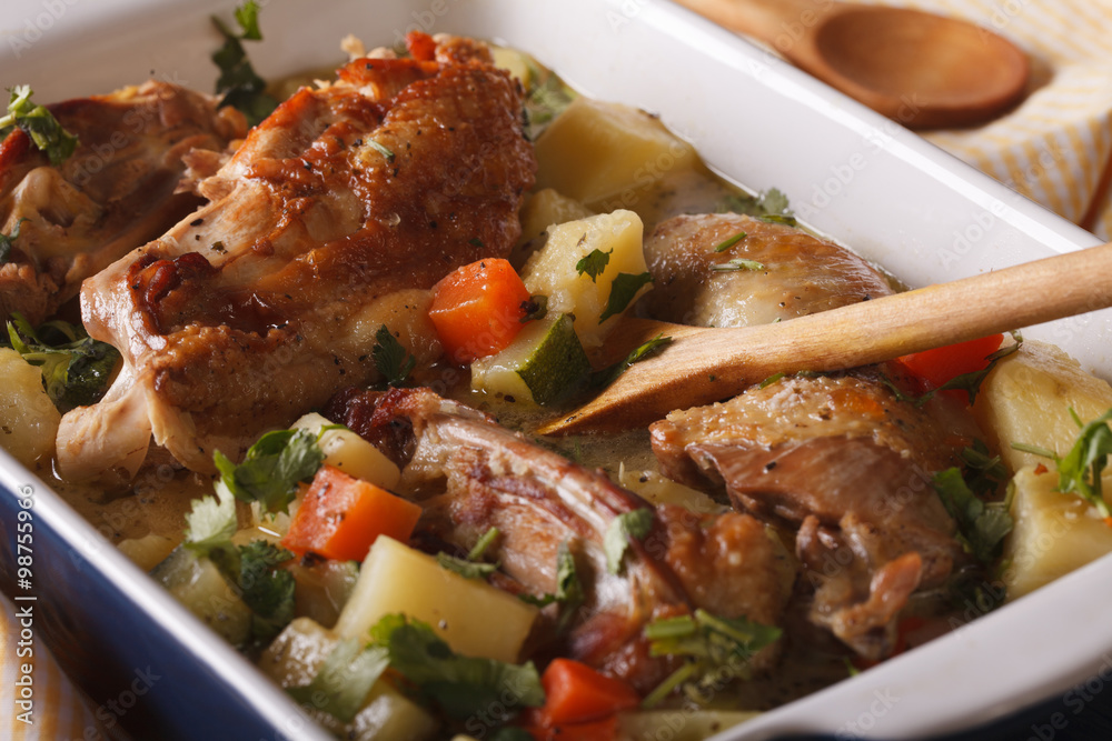 Pieces of chicken stew with potatoes in a dish close-up. Horizontal
Pieces of chicken stew with potatoes in a dish close-up. Horizontal