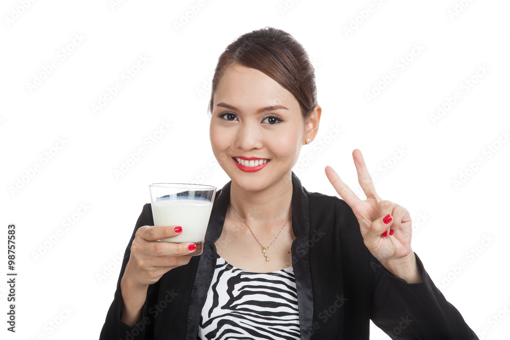 Healthy Asian woman drinking a glass of milk show victory sign Healthy Asian woman drinking a glass of milk show victory sign