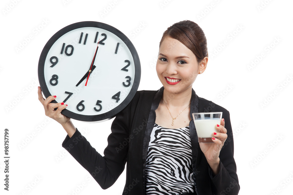 Healthy Asian woman drinking glass of milk hold clock Healthy Asian woman drinking glass of milk hold clock