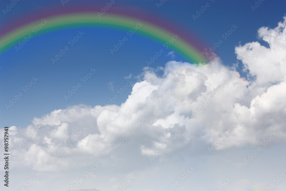 Blue sky with clouds and a rainbow Blue sky with clouds and a rainbow