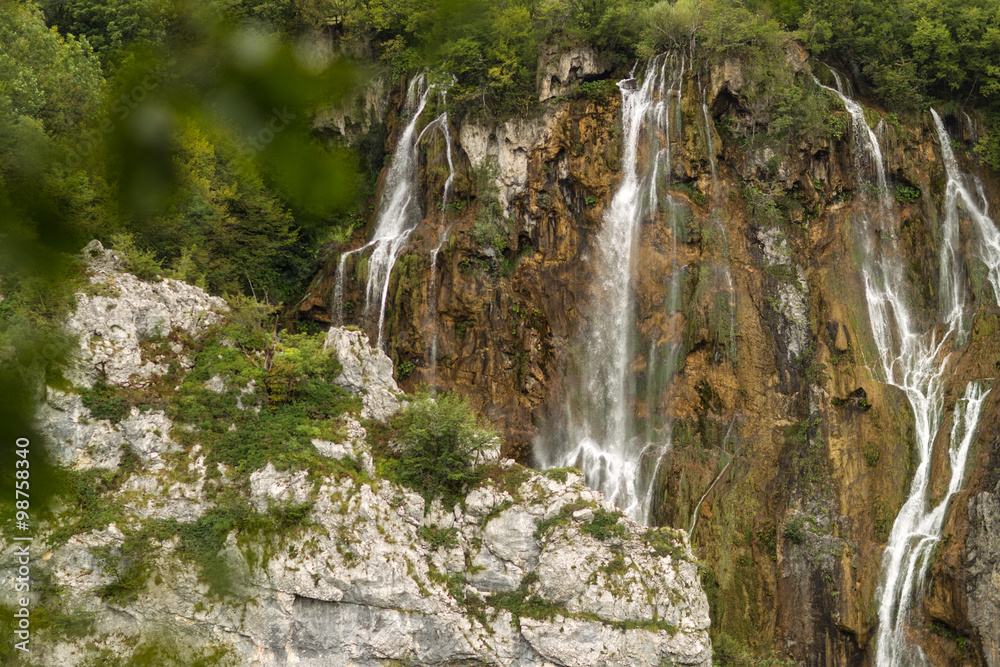 Fototapeta premium Beautiful waterfalls among green mountains