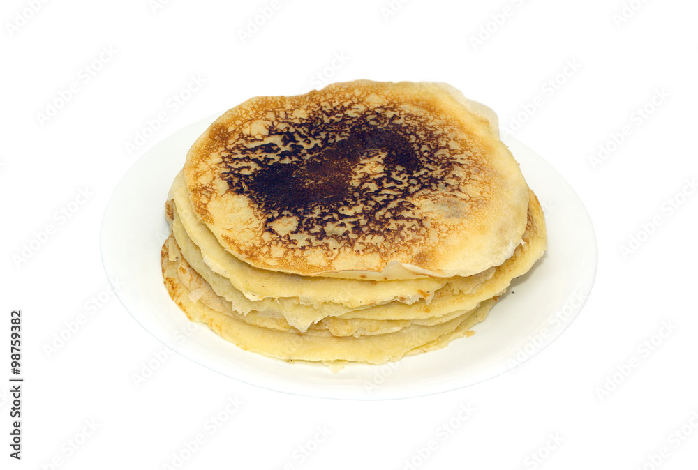 Stack of many fried pancakes on round white plate isolated on white background. Photo closeup Stack of many fried pancakes on round white plate isolated on white background. Photo closeup