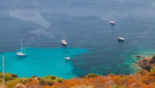 Yachts moored in azure bay, South Corsica