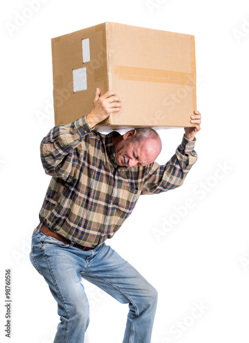 Senior man carries a heavy box
