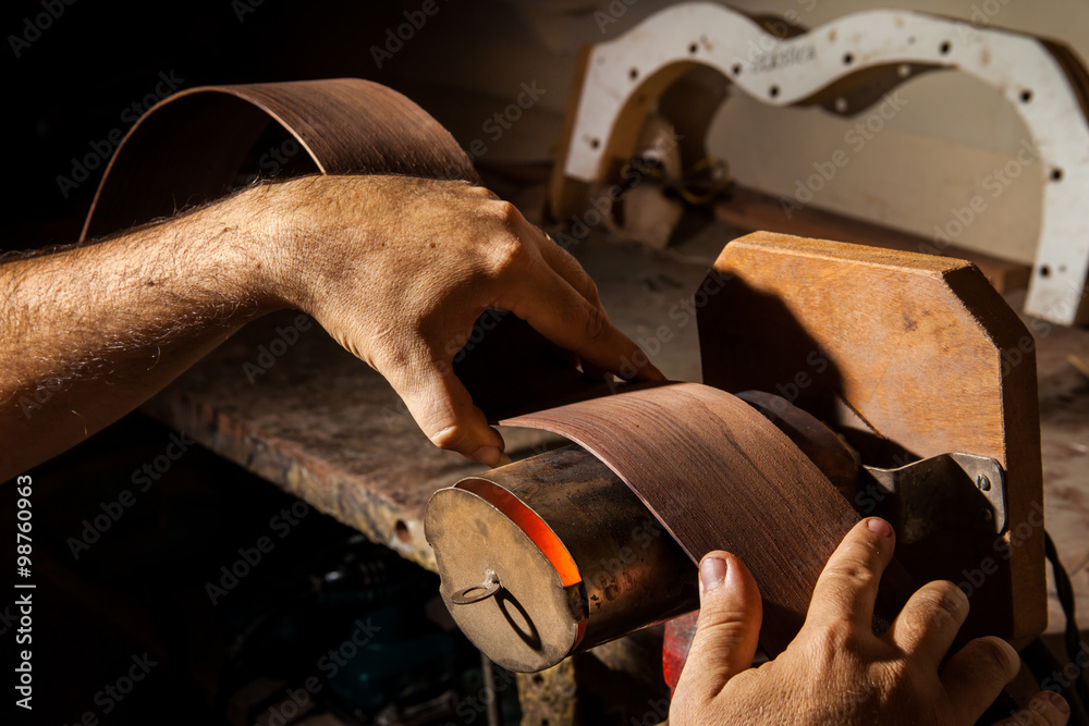 Fototapeta premium Luthier making an acoustic guitar