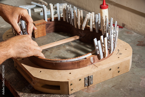 Luthier making an acoustic guitar body